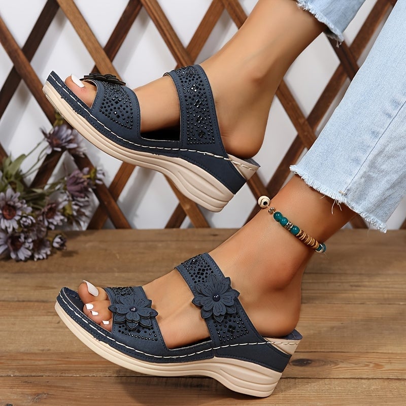 Model wearing Heath floral wedge slides in light brown with a summer dress
