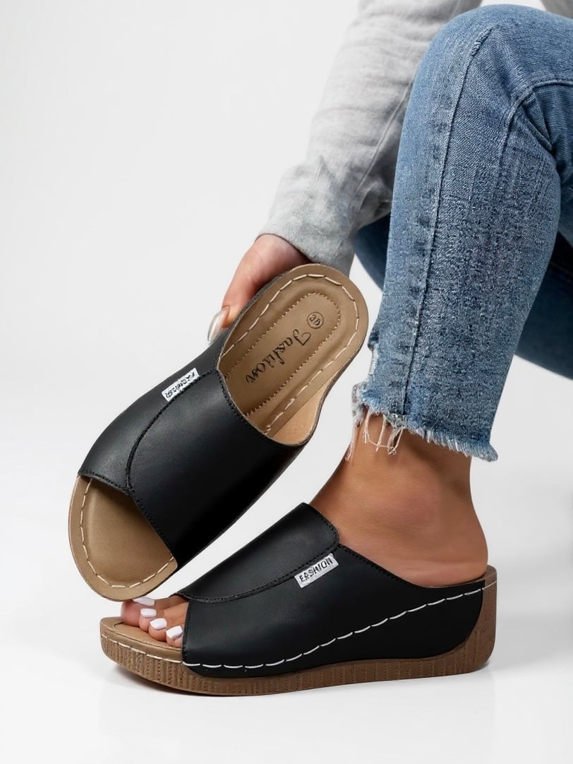 Heather platform slides in brown, three-quarter angle highlighting sleek minimalist silhouette