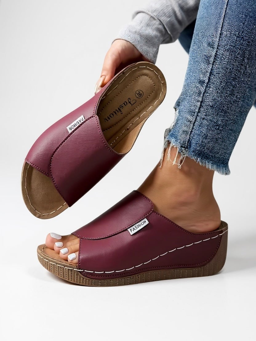 Heather women's slides in blue, side profile view emphasizing lightweight sole and modern design