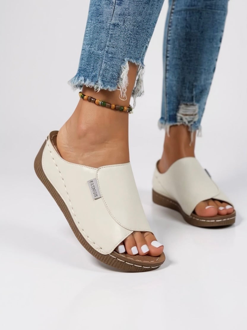 Heather platform slides in white being worn, showing comfortable fit and elevated sole