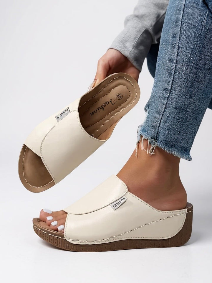Pair of Heather platform cushioned slides in black, both shoes displayed from above