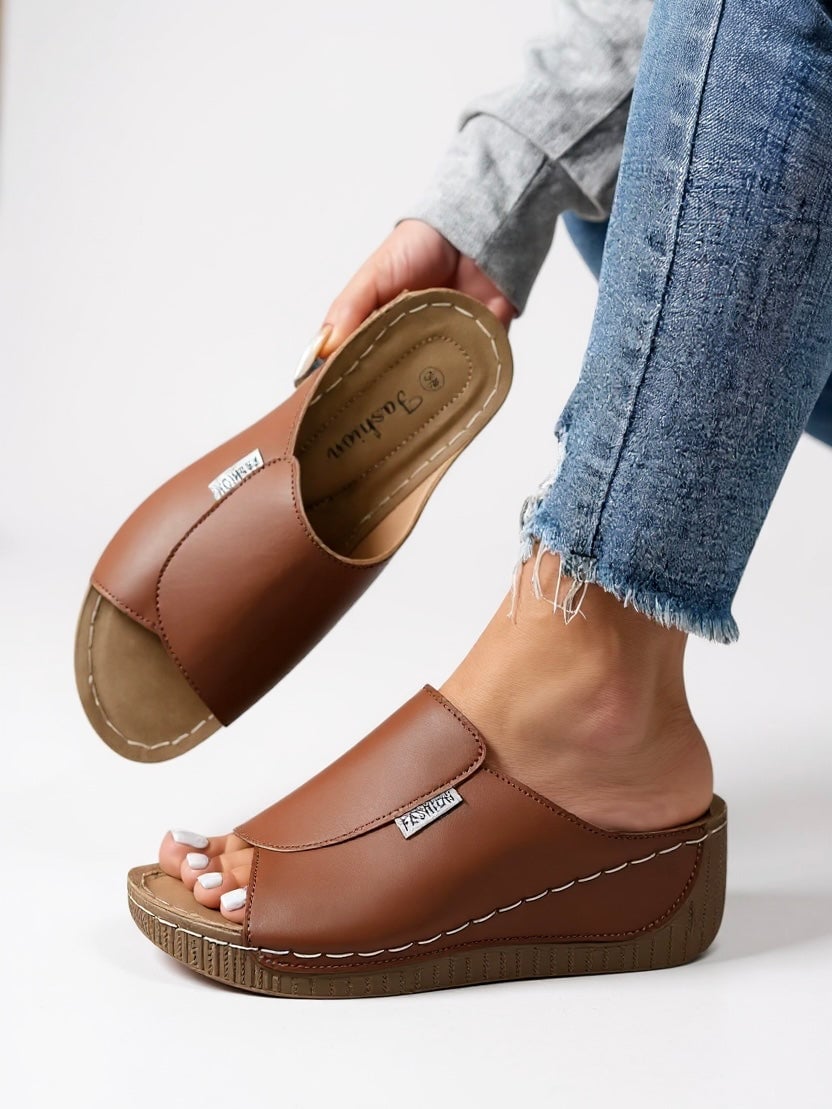 Heather slides in brown, back-angle view showing platform sole construction and heel detail