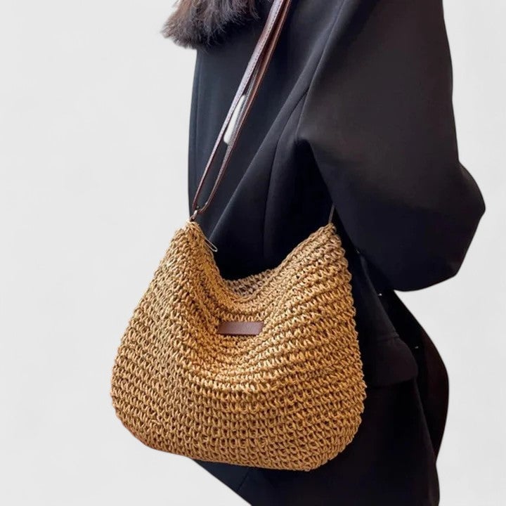Hedda shoulder bag in khaki held by a model wearing a casual everyday look