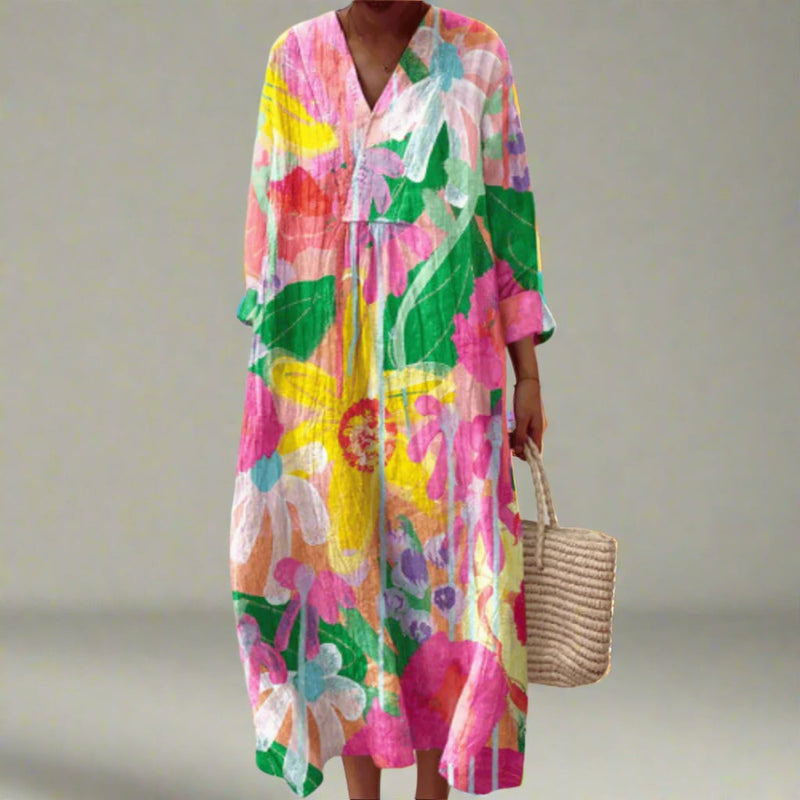 Woman wearing the Helen elegant geometric dress featuring a bold dream-inspired print and flowing silhouette