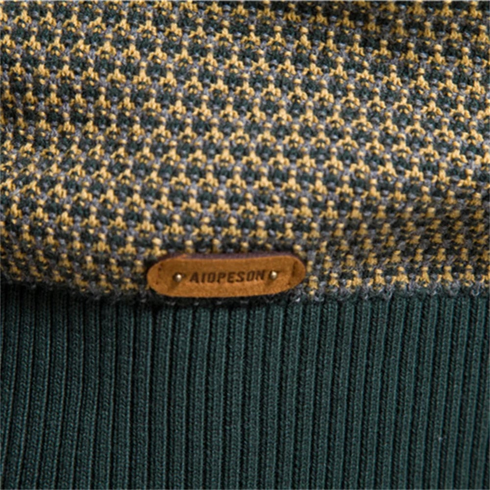Men's checkered sweater in orange colorway styled casually with jeans