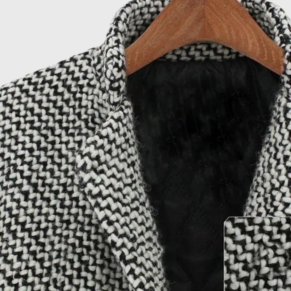 Detail shot of the Herlie winter coat pocket and closure on a grey insulated fabric background