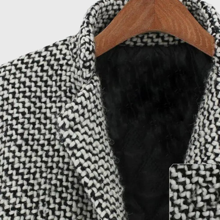 Detail shot of the Herlie winter coat pocket and closure on a grey insulated fabric background