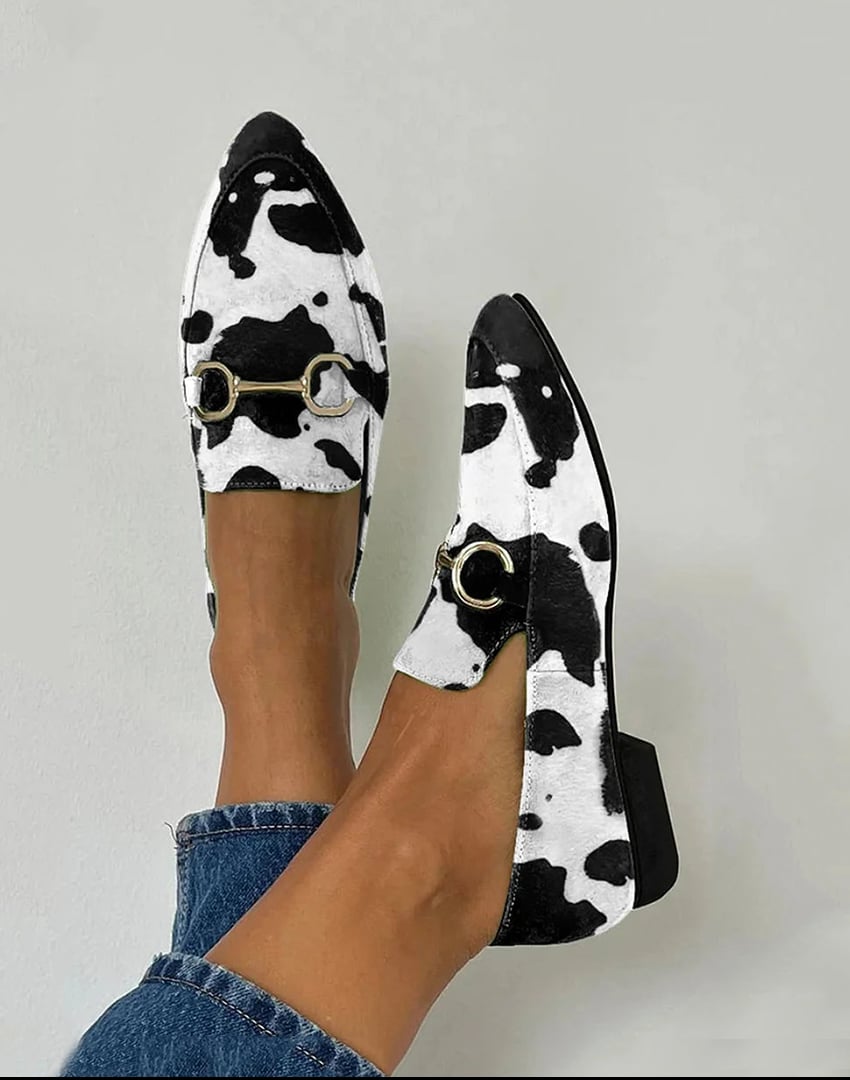 Black and white Hollie loafers with a sleek silhouette and subtle chic detailing, shown from a front angle
