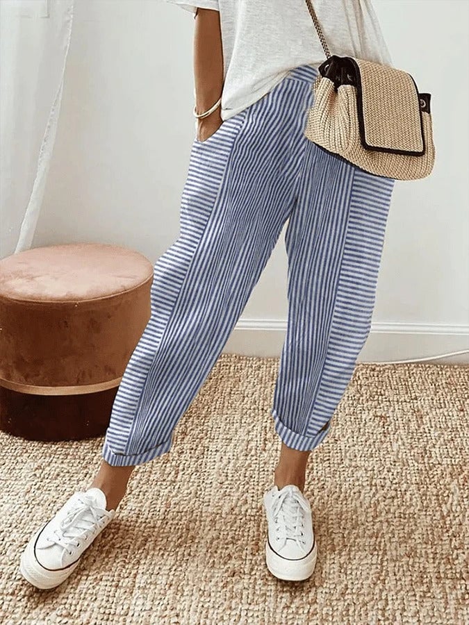 Model wearing relaxed striped pull-on pants with an elastic waistband in a casual daytime setting