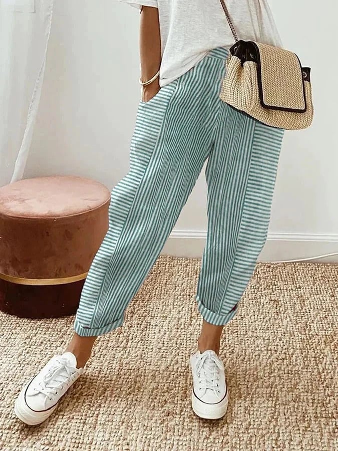 Model wearing purple striped pull-on pants styled with a casual top