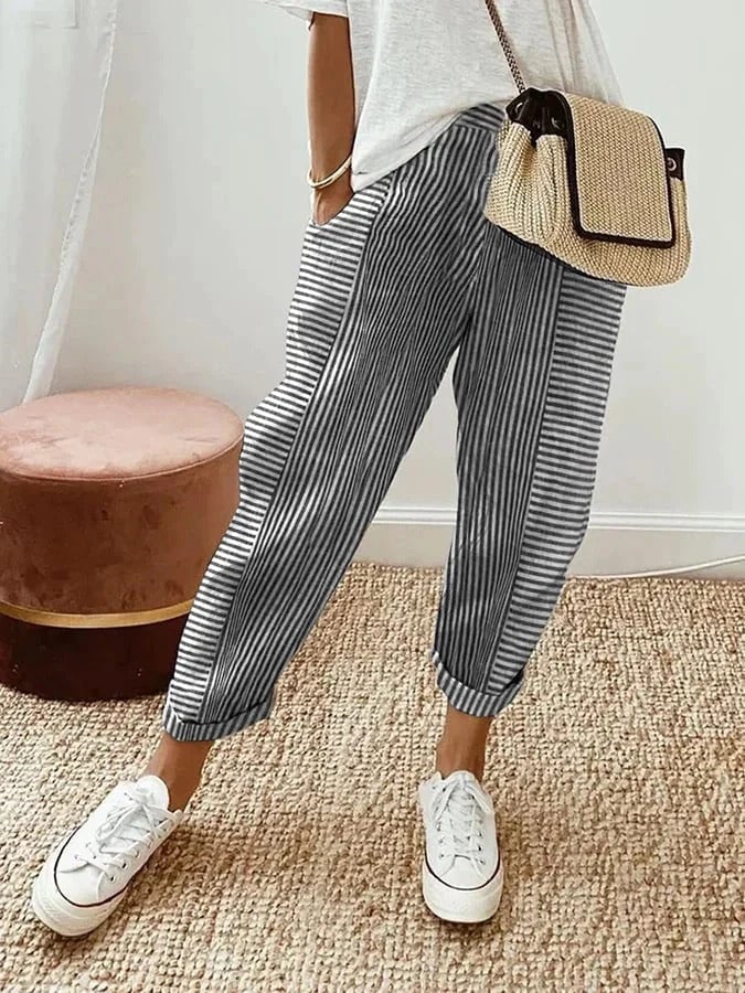Full-length view of model in striped pants showing the relaxed straight-leg silhouette