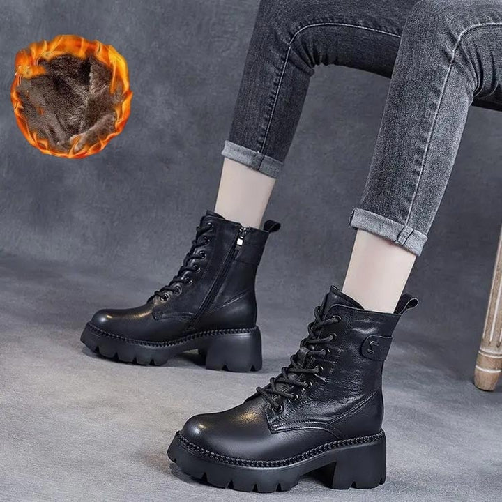 Holly orthopedic boots in black styled with dark slim trousers on a model