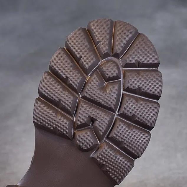 Model walking in Holly orthopedic boots in brown on a neutral background