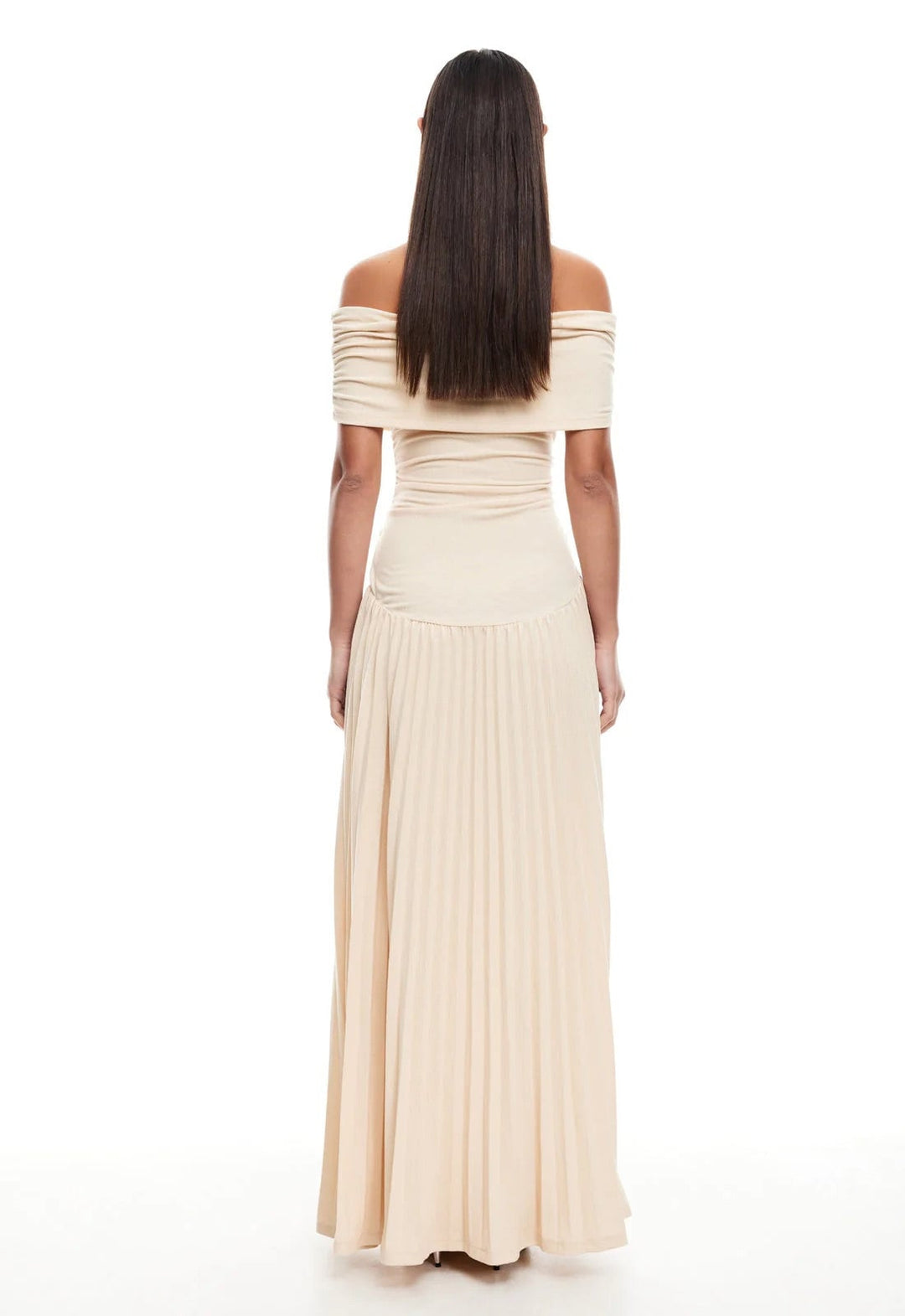 Woman in a navy maxi dress styled with strappy sandals at an outdoor summer brunch setting