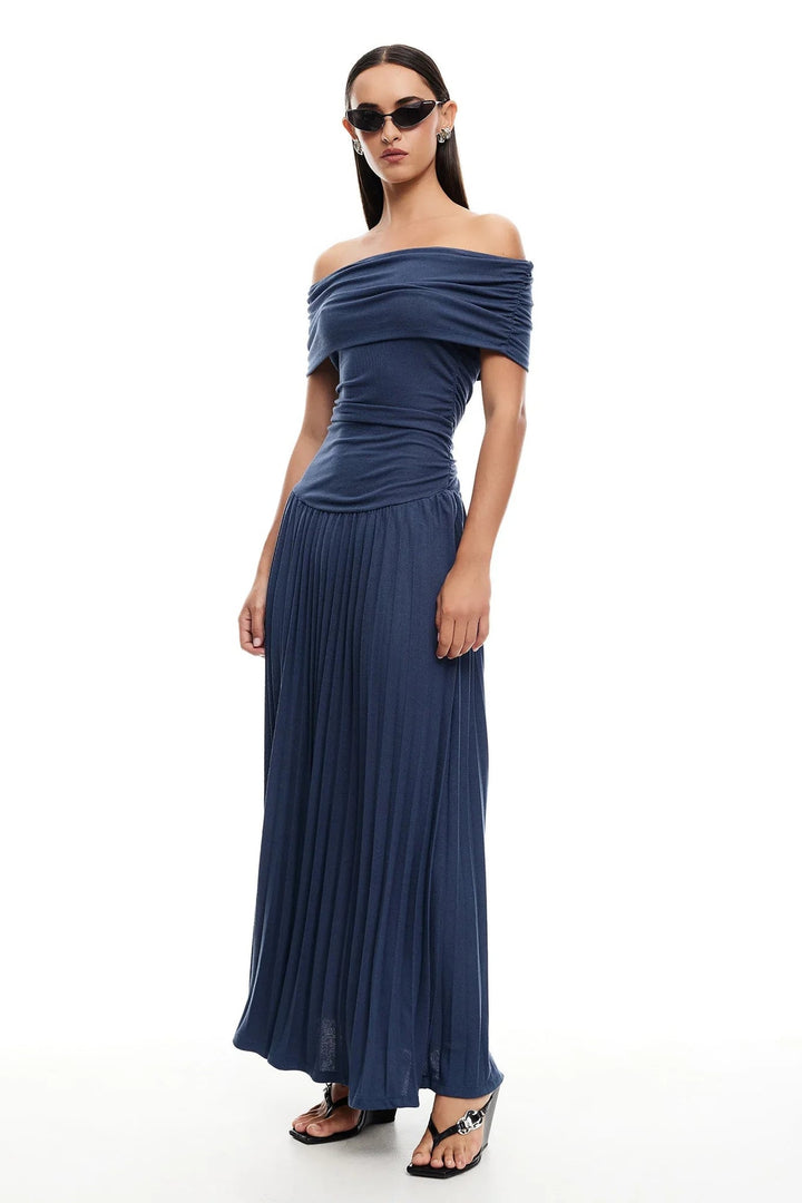 Close-up of the hem of a sky blue maxi dress in motion, showcasing lightweight airy fabric quality