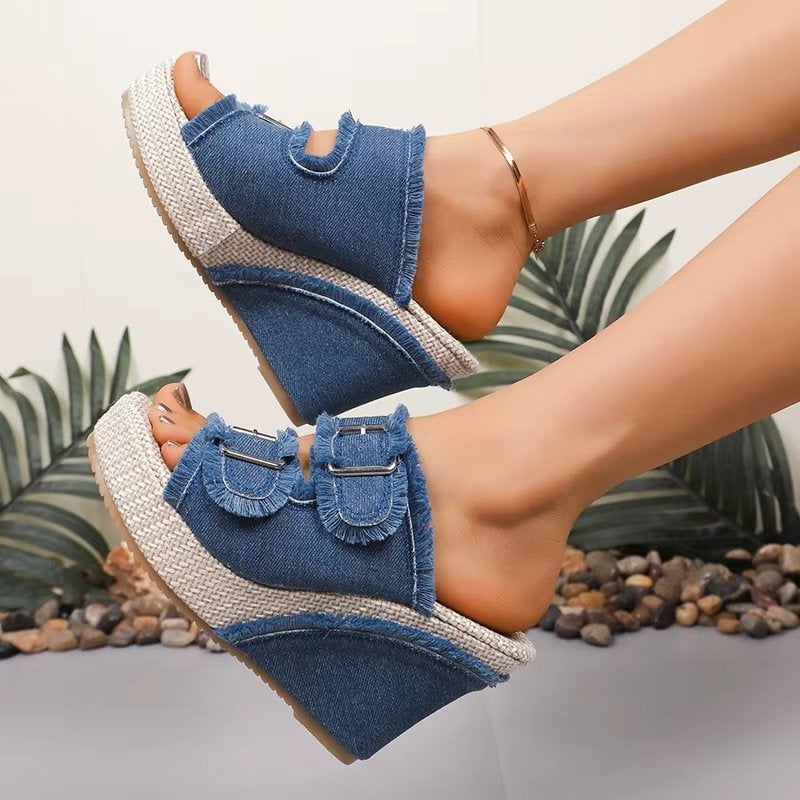 Blue denim chunky wedge sandals with adjustable buckle straps, front three-quarter view