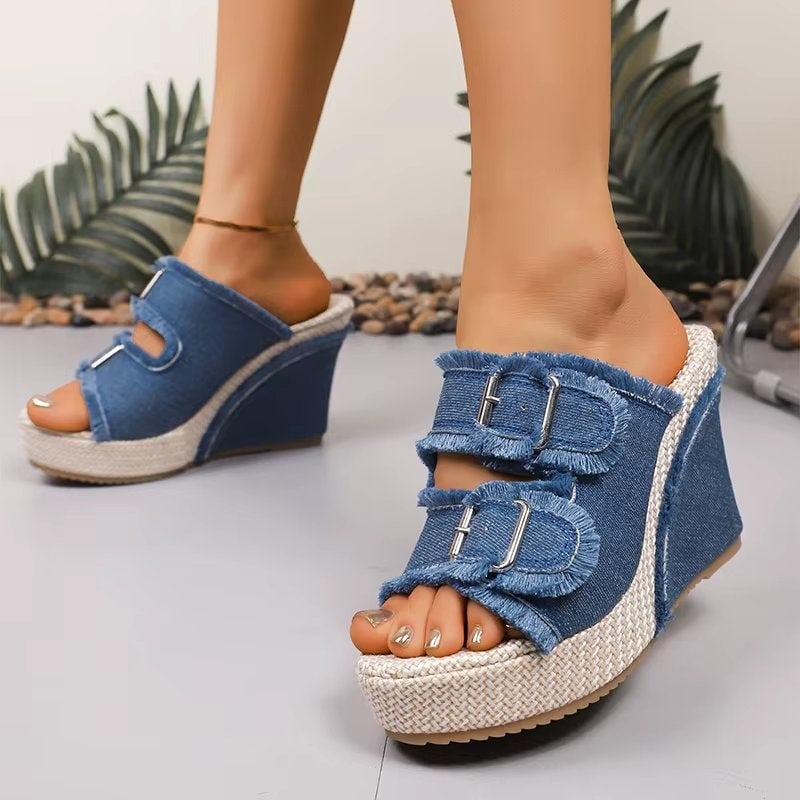 Close-up of adjustable buckle strap detail on blue denim wedge sandals
