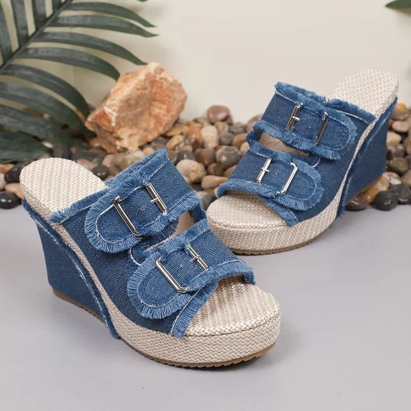 Top-down view of blue denim wedge sandals showing textured upper and open toe