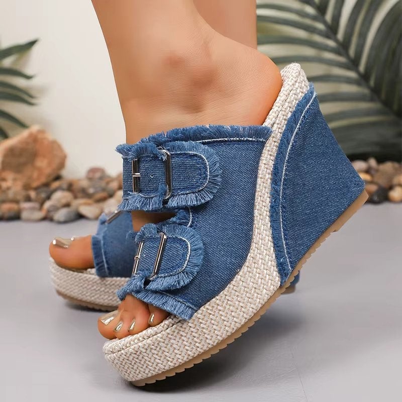 Blue denim wedge sandals styled with a floral summer dress on a model
