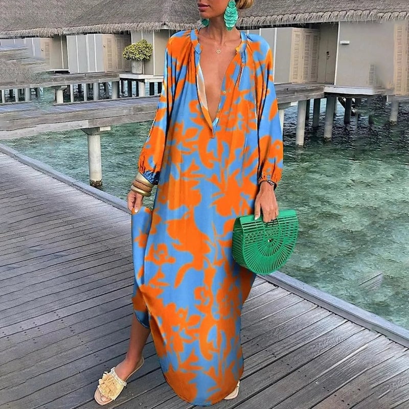 Front view of an orange abstract print draped kaftan in a relaxed fit