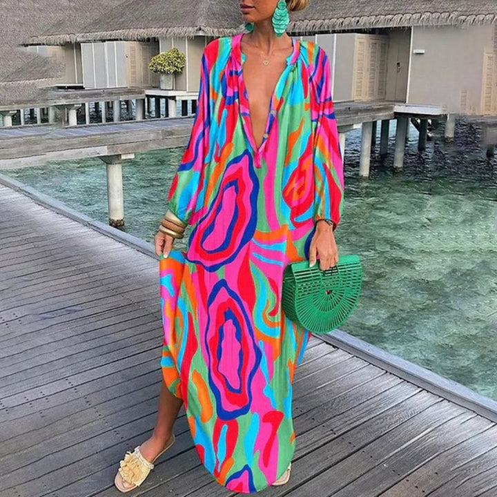 Full-length side view of a woman in a flowing abstract print beach cover-up kaftan