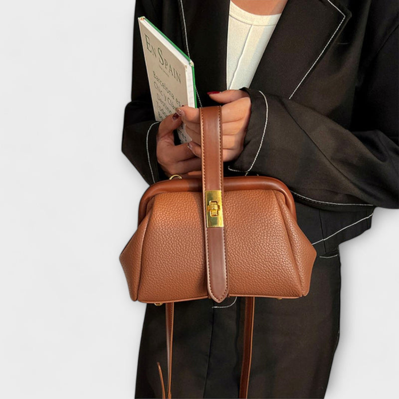 Black elegant mini handbag with gold hardware shown from the front