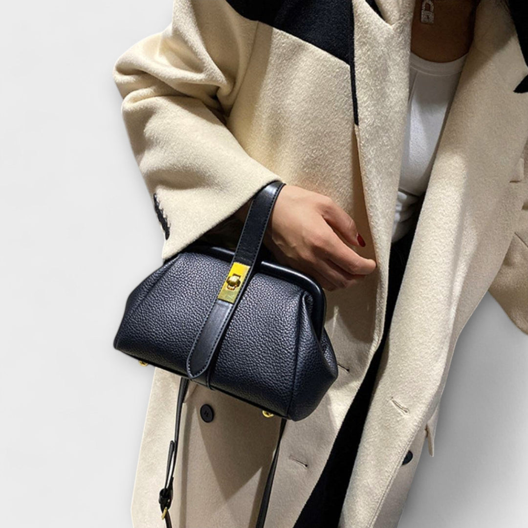 Side profile of structured mini handbag showing shape and depth