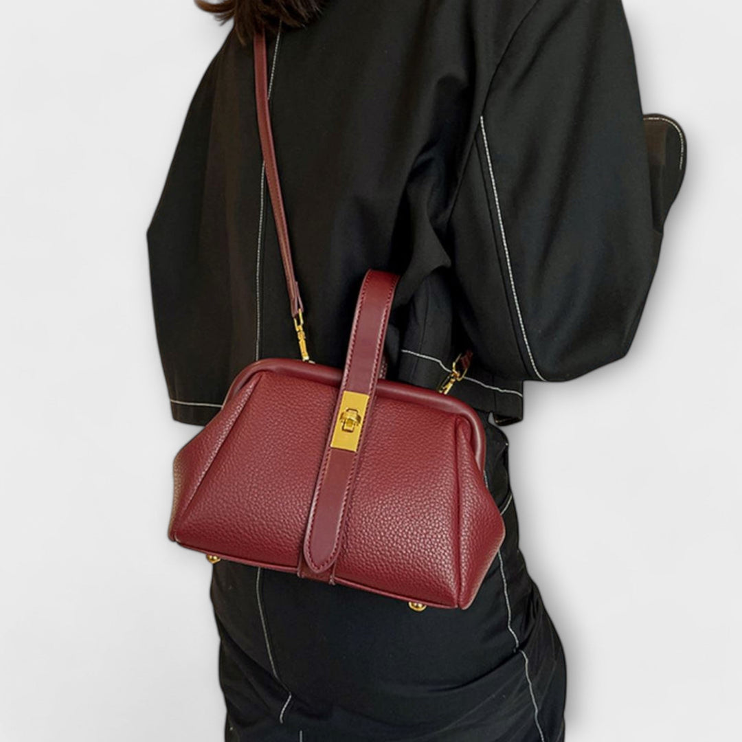Close-up of clasp and stitching detail on elegant mini handbag