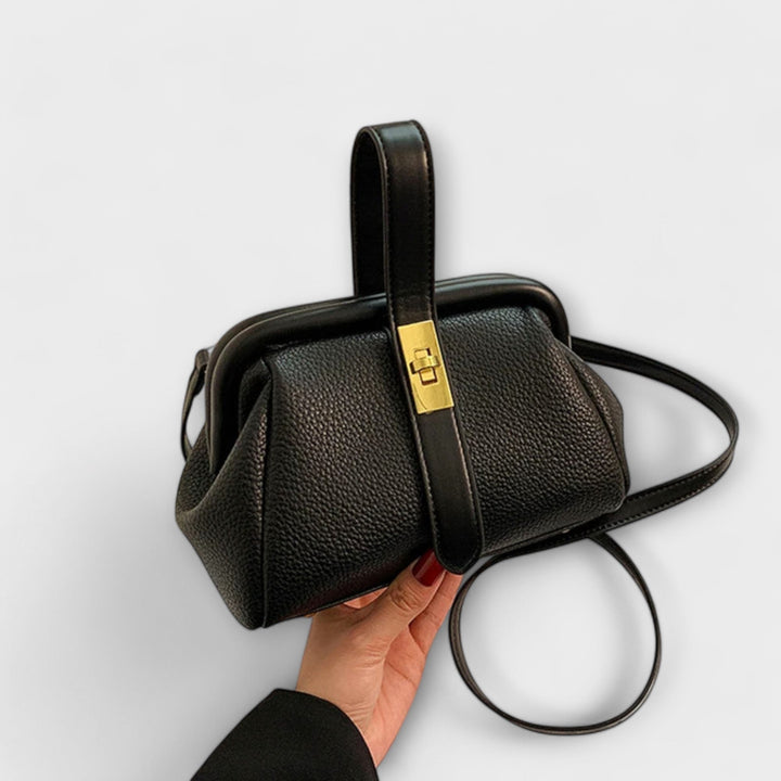 Model carrying red mini handbag over the shoulder at a social event
