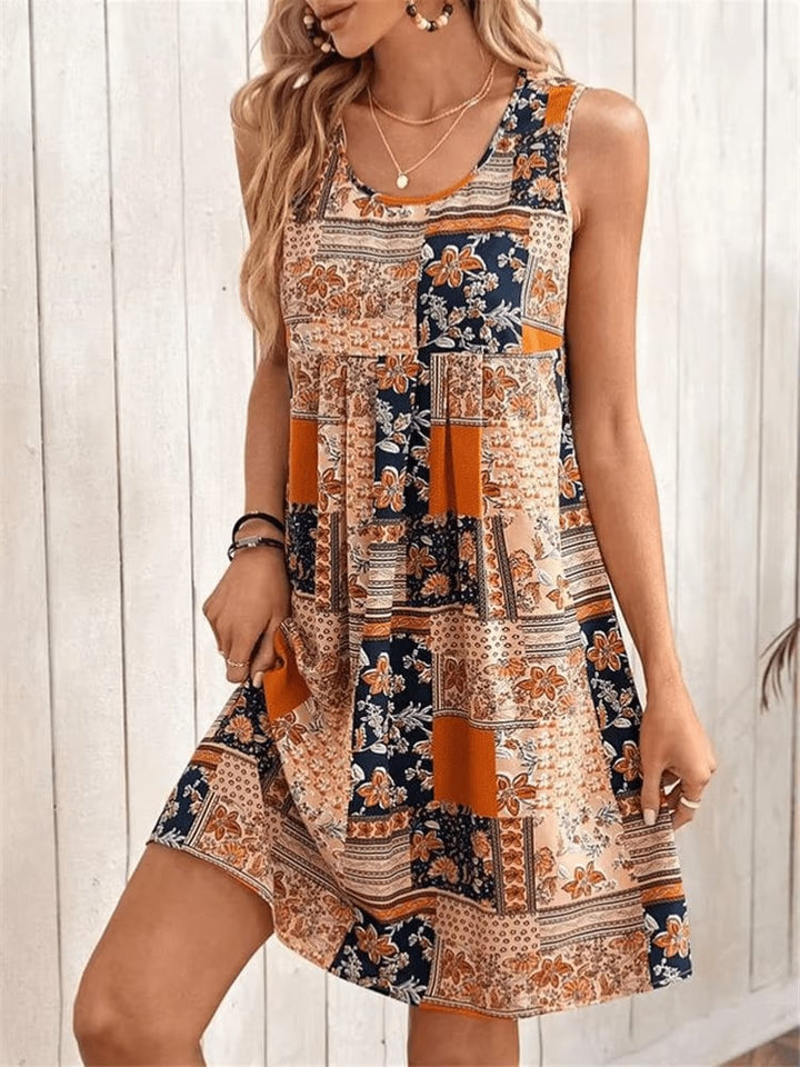 Front view of the Indie boho patchwork sleeveless mini dress in orange with floral and geometric print