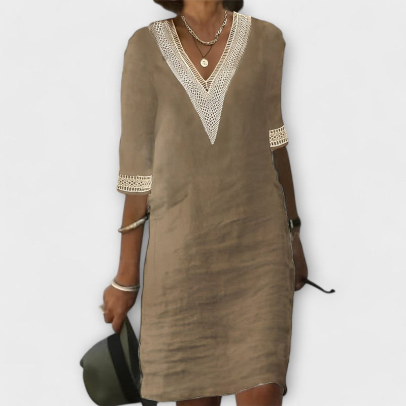 Side view of a woman in a gray crochet dress highlighting the airy silhouette and feminine design