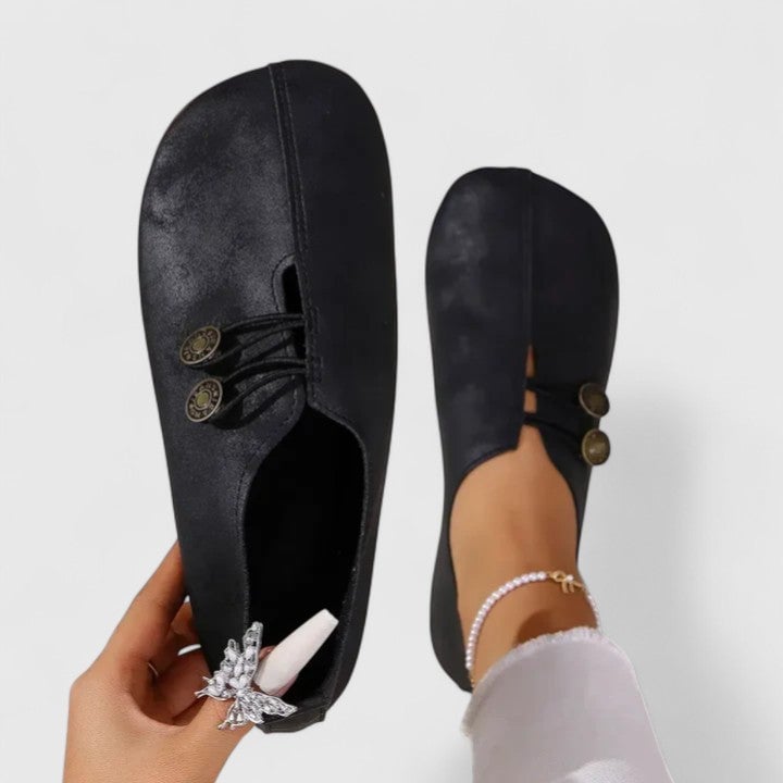 Front view of Irene elegant loafers in black with a sleek polished silhouette on a clean background