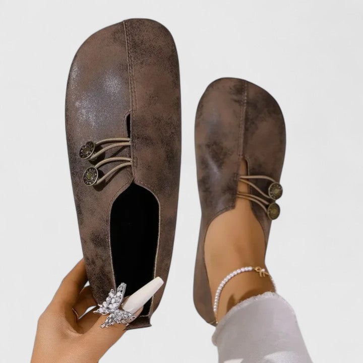 Close-up of Irene elegant loafers in dark brown showing subtle accent detailing and smooth finish
