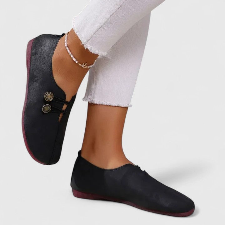 Pair of Irene elegant loafers in black styled with tailored trousers for an office-ready look