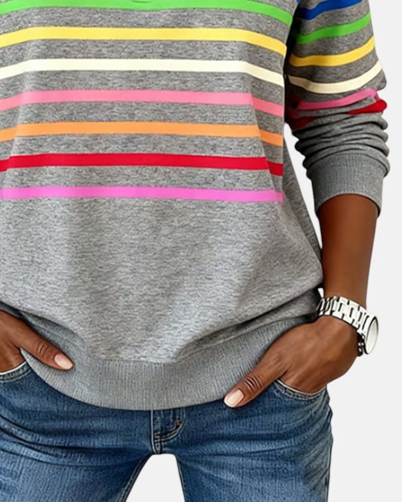 Khaki rainbow striped zip sweatshirt on model in a casual everyday outfit