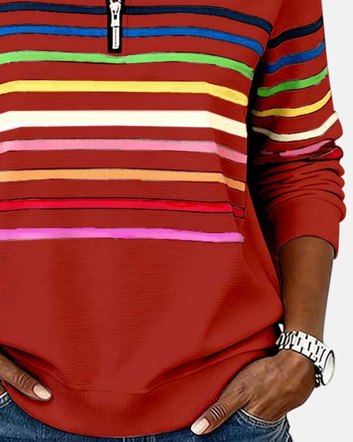 Full-length view of woman in rainbow striped zip sweatshirt showing overall fit