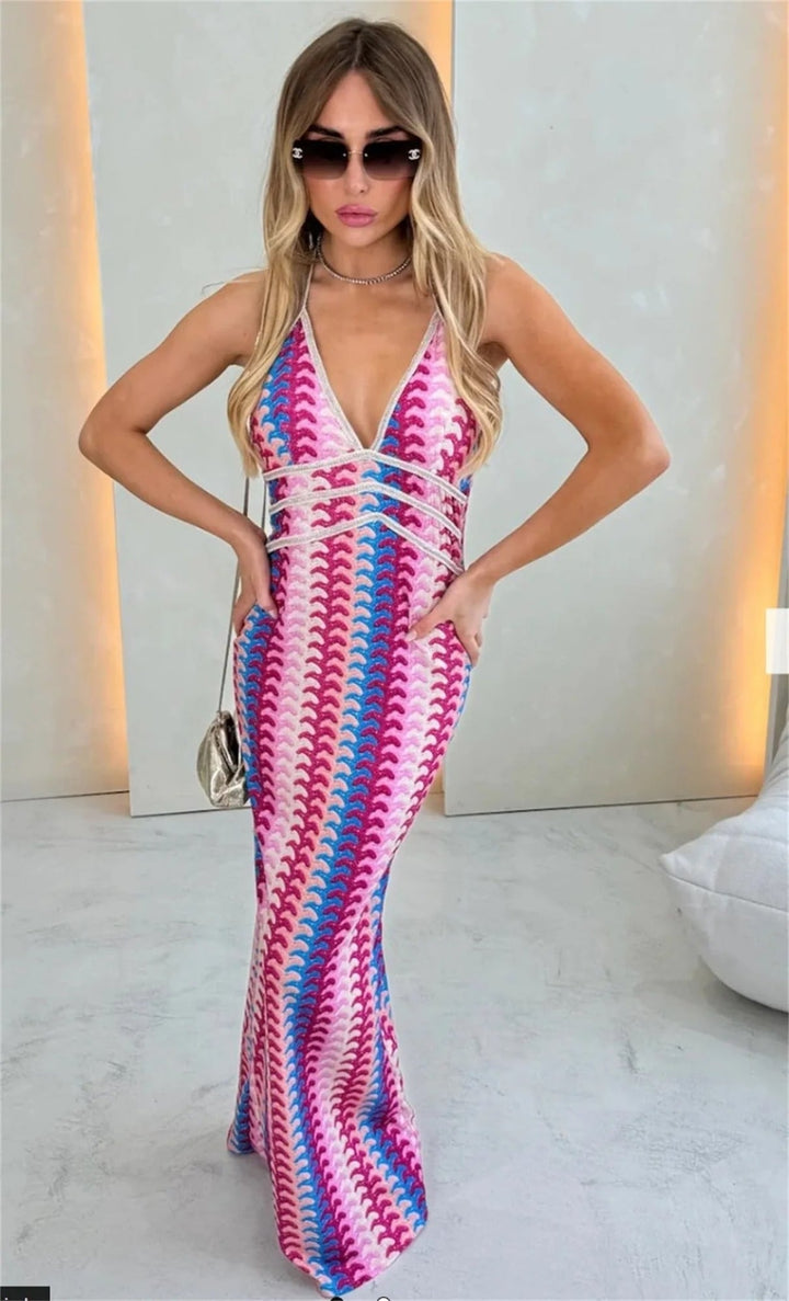 Model layering the Iris crochet draped dress over swimwear on a sunny beach