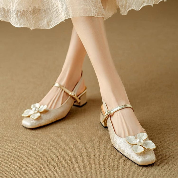 Close-up of pearl floral embellishment on Isabeau mary jane pumps in beige