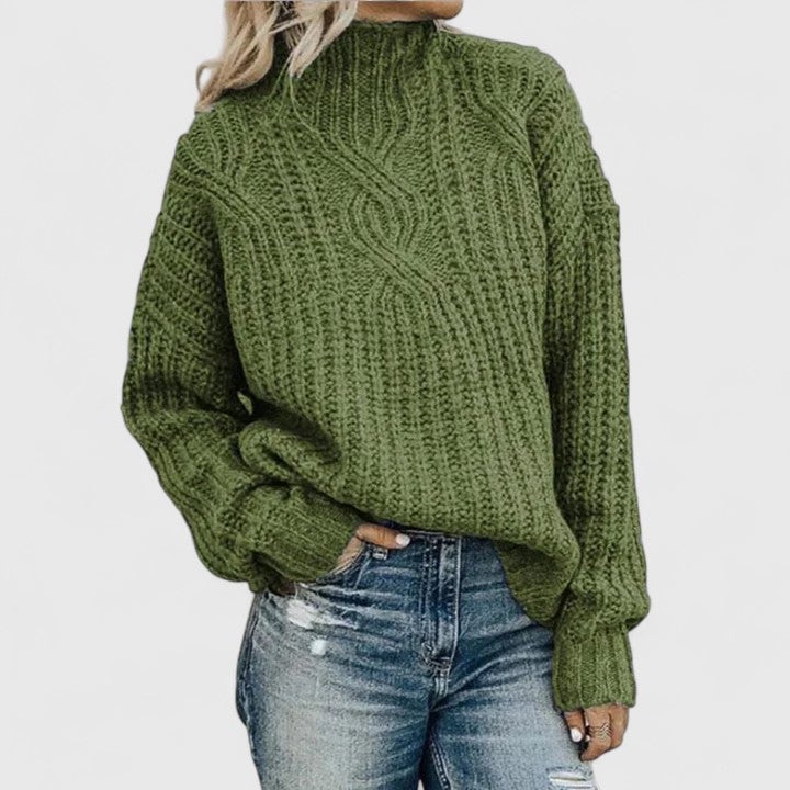Woman wearing the Isabel sophisticated sweater in a relaxed, elegant pose showing the figure-flattering drape and smooth silhouette