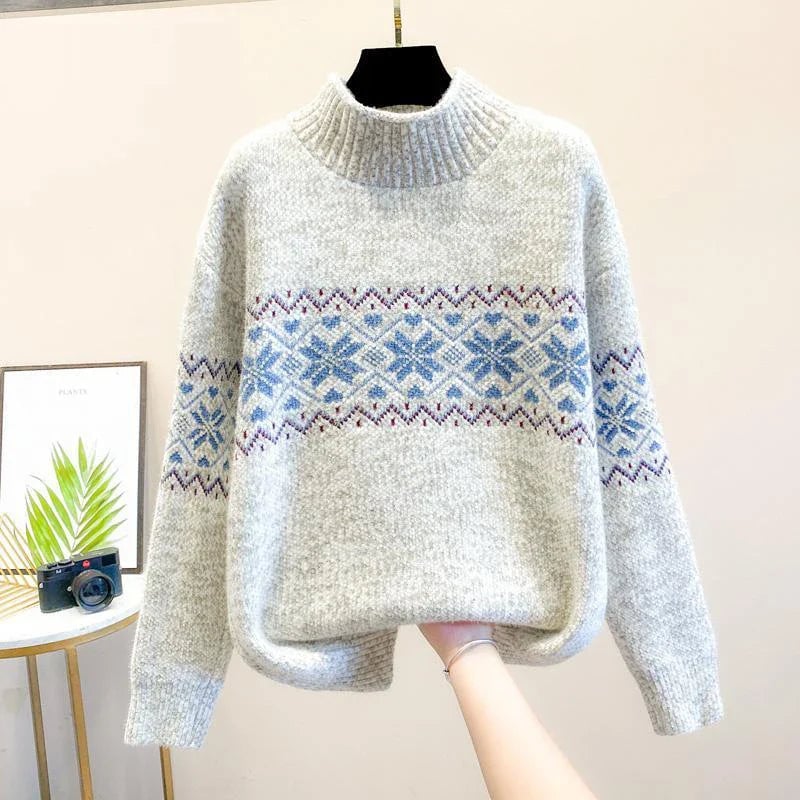 Model wearing a relaxed-fit snowflake sweater in beige paired with jeans