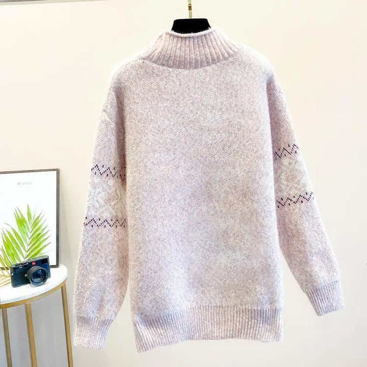 Detail shot of the high neckline and snowflake texture on a knit sweater