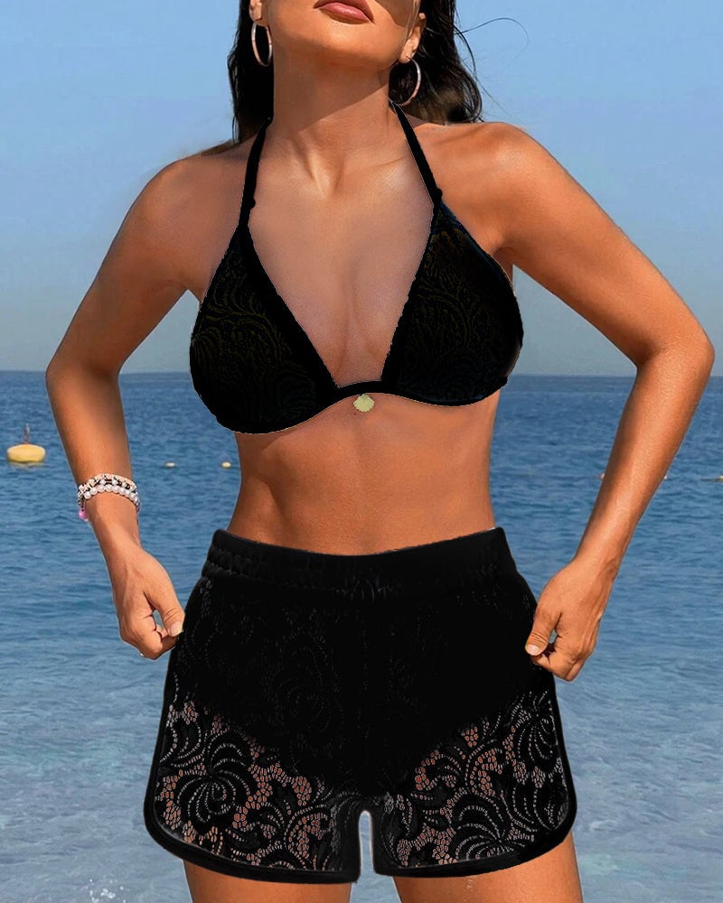 Flat lay of the Isabella bikini set in both white and black colorways on a light neutral background