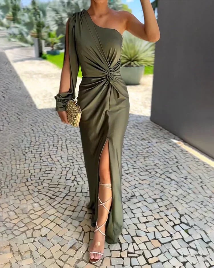 Woman wearing the Isabella green pleated wedding guest dress with a graceful neckline and soft arm coverage