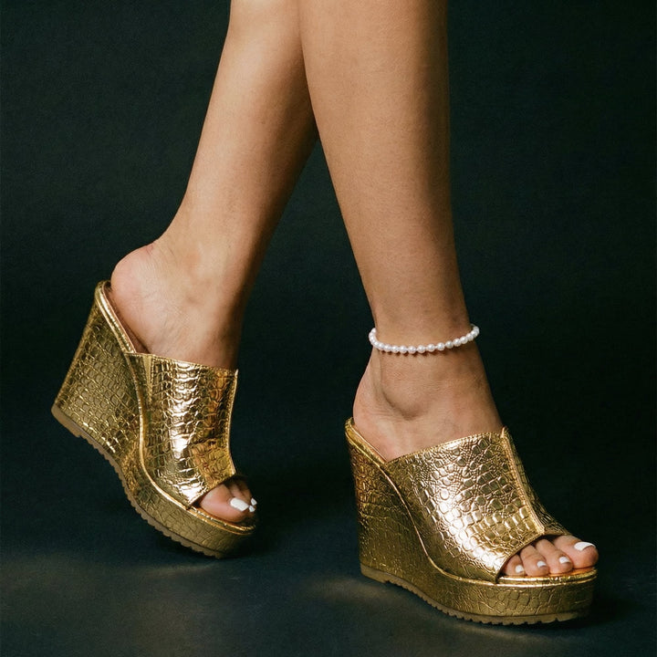 Rear view of Isadora gold platform wedge sandals highlighting the heel height