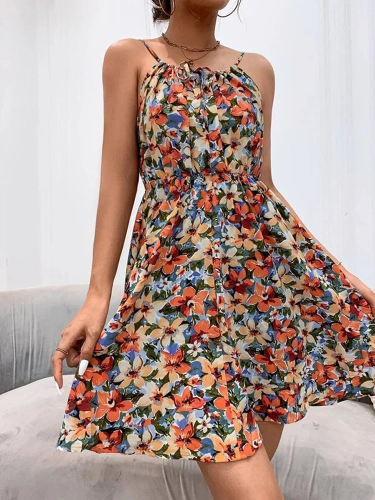 Full-length view of the Florimay floral halter dress in orange showing the flowing A-line silhouette