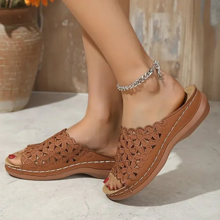 Side view of Isla women's sandals in brown showing delicate floral detailing