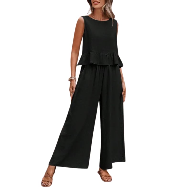 Close-up of the Isla two-piece set in black showing ruffle hem tank detail and relaxed wide-leg pant silhouette