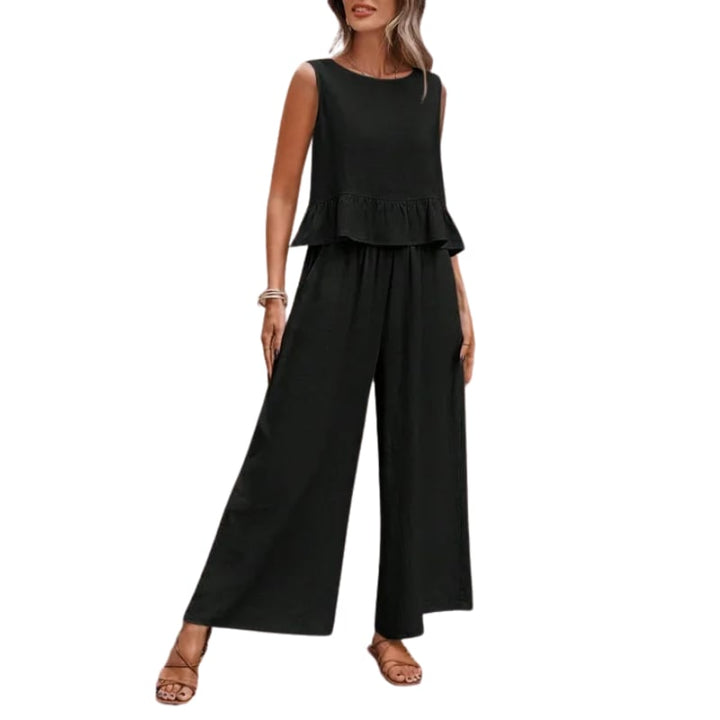 Close-up of the Isla two-piece set in black showing ruffle hem tank detail and relaxed wide-leg pant silhouette