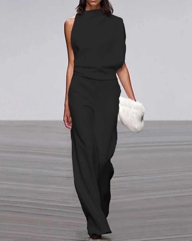 Close-up of mock neck and draped shoulder detail on ivory sleeveless jumpsuit
