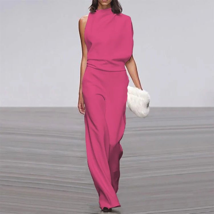 Full-length lifestyle shot of sleeveless wide-leg jumpsuit in ivory at a formal event setting